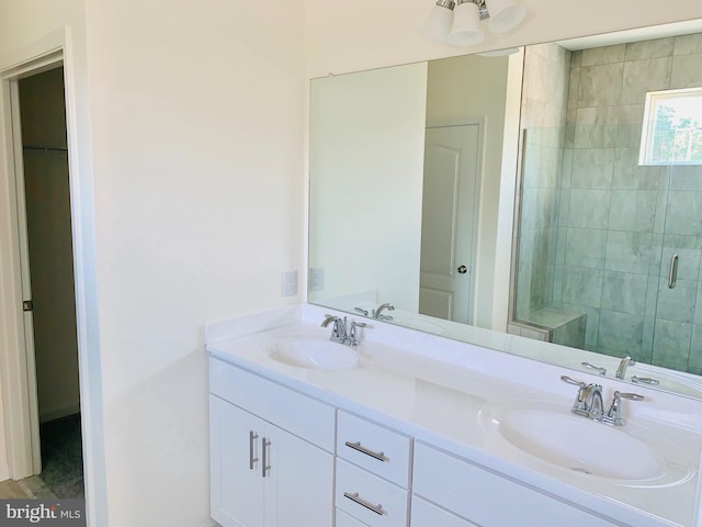 bathroom featuring walk in shower, dual sinks, and vanity with extensive cabinet space