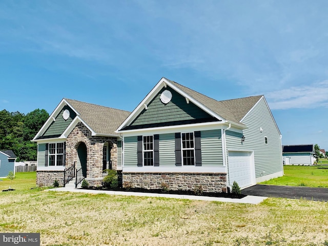 craftsman-style house featuring a front lawn and a garage