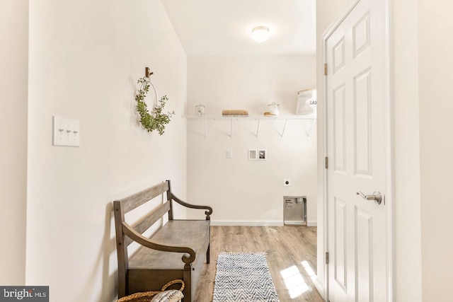 interior space with hookup for a washing machine, hookup for an electric dryer, and light wood-type flooring