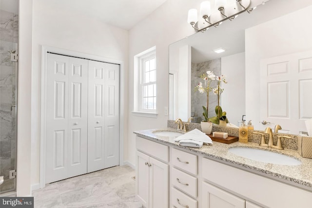 bathroom featuring a shower with shower door, dual bowl vanity, and tile flooring