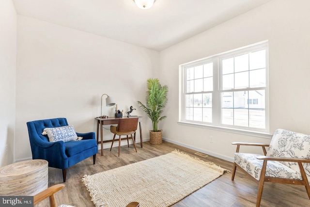 sitting room featuring plenty of natural light and hardwood / wood-style flooring