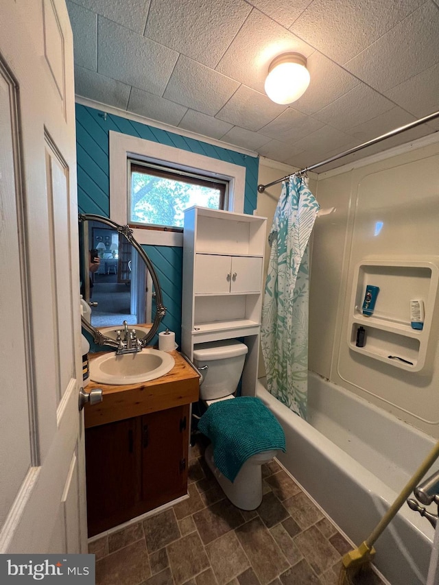 full bathroom featuring shower / bath combination with curtain, tile flooring, toilet, and vanity with extensive cabinet space