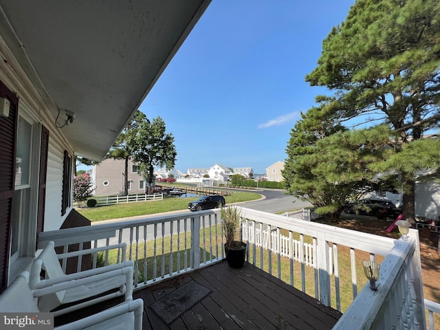 wooden deck featuring a yard