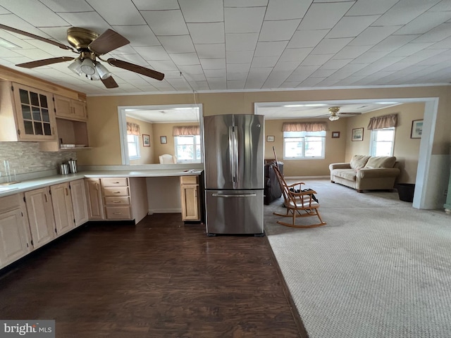 kitchen featuring ceiling fan, stainless steel refrigerator, dark hardwood / wood-style floors, and a wealth of natural light