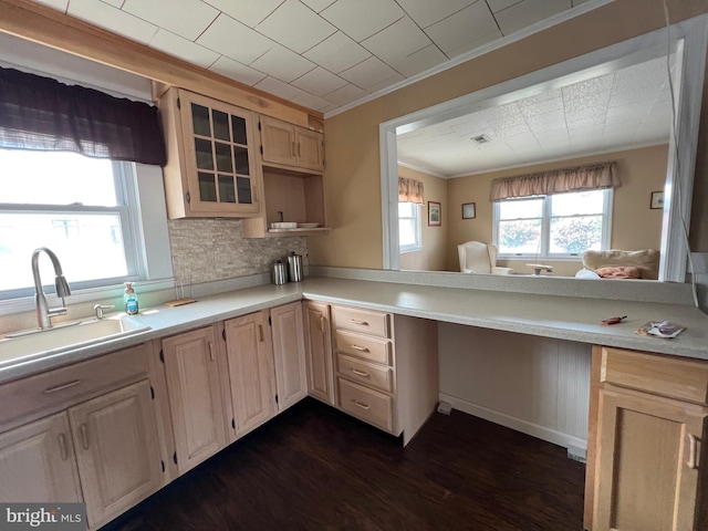 kitchen featuring light brown cabinetry, backsplash, dark hardwood / wood-style flooring, kitchen peninsula, and crown molding