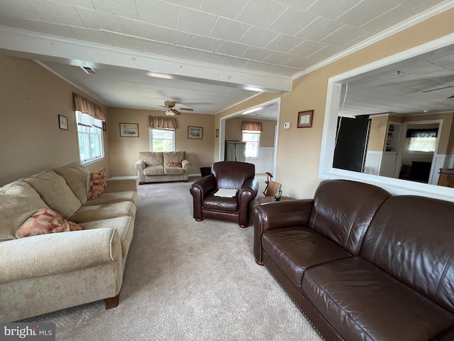 living room with ceiling fan, ornamental molding, and light colored carpet