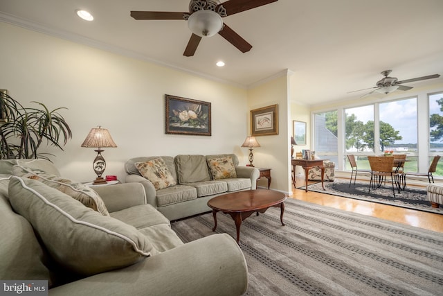 living room with ceiling fan, ornamental molding, and hardwood / wood-style flooring