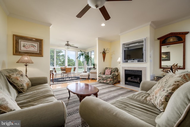 living room with ceiling fan, crown molding, light hardwood / wood-style flooring, and radiator heating unit