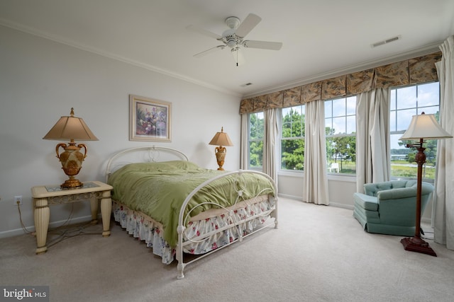 carpeted bedroom featuring ceiling fan and ornamental molding