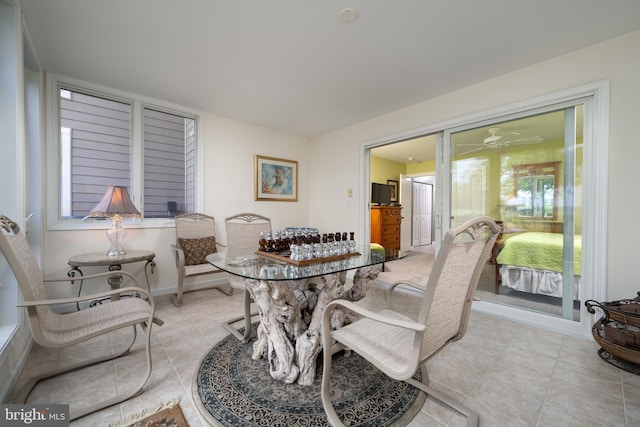 dining room with ceiling fan, plenty of natural light, and light tile floors