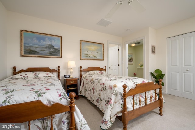 carpeted bedroom featuring ceiling fan and a closet