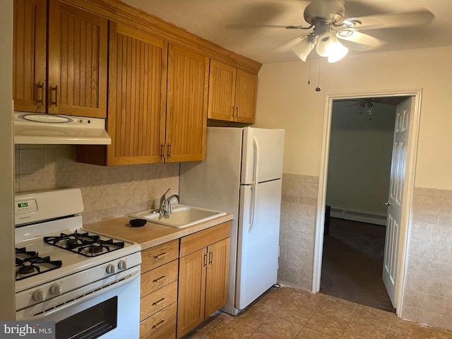 kitchen featuring a baseboard heating unit, ceiling fan, white appliances, tile flooring, and sink