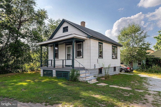 view of front of house with a porch and a front lawn