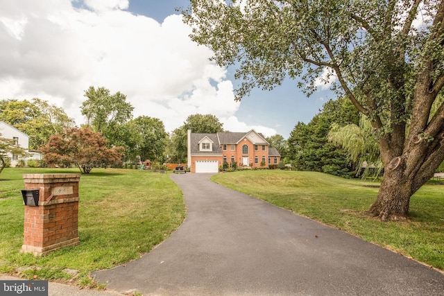 view of front of house featuring a front yard and a garage