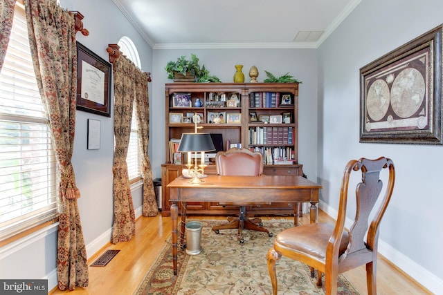 home office featuring crown molding and light wood-type flooring