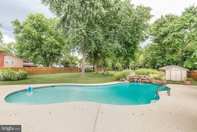 view of swimming pool featuring pool water feature, a patio area, a lawn, and a shed