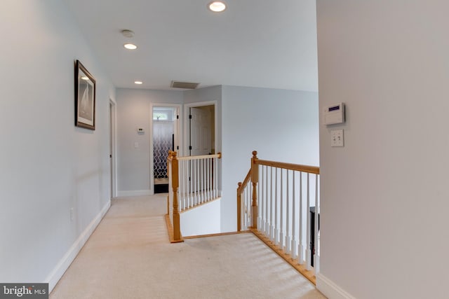 hallway featuring light carpet