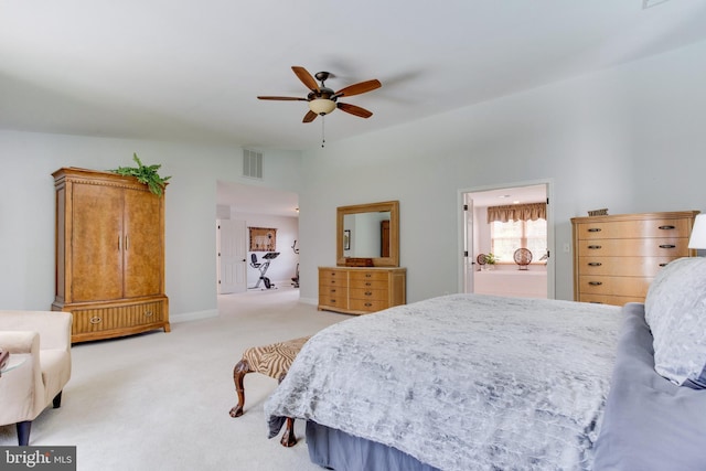 carpeted bedroom with connected bathroom and ceiling fan