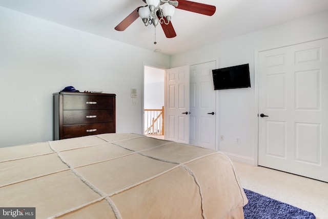 bedroom featuring light carpet and ceiling fan