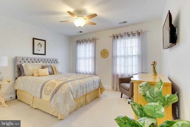 bedroom featuring light colored carpet and ceiling fan