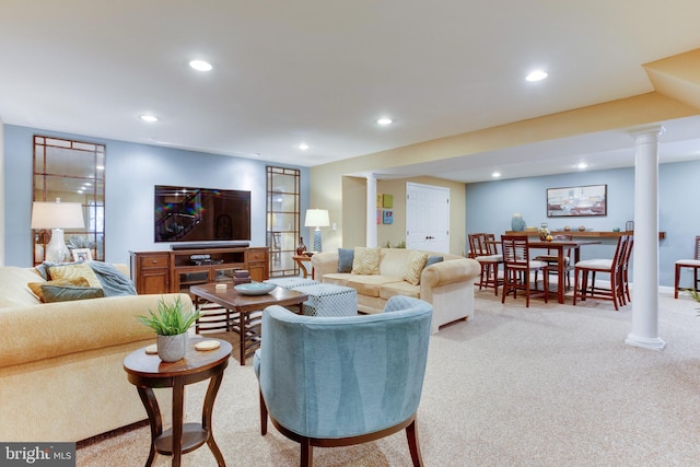 carpeted living room featuring decorative columns