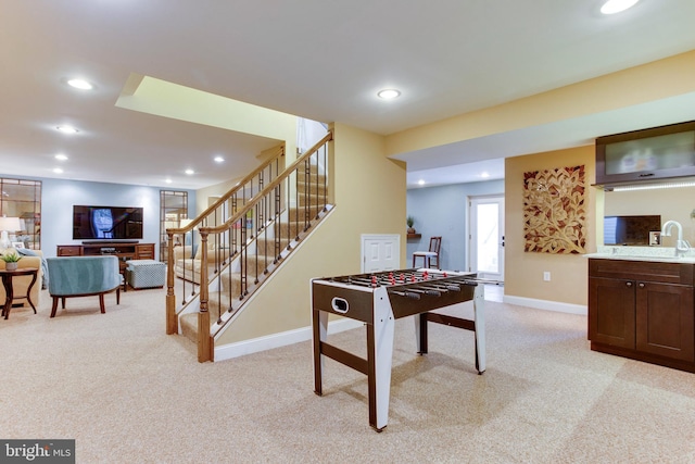 rec room with light carpet and sink