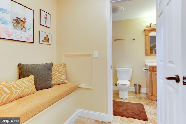 bathroom featuring toilet, tile flooring, and vanity