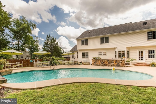 view of swimming pool with a yard and a patio