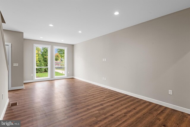 unfurnished room featuring dark hardwood / wood-style flooring