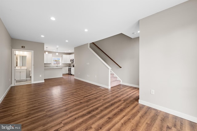 unfurnished living room featuring dark hardwood / wood-style floors