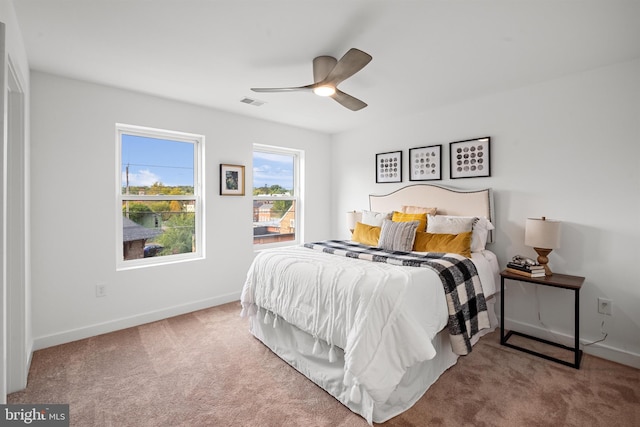 bedroom featuring light carpet and ceiling fan