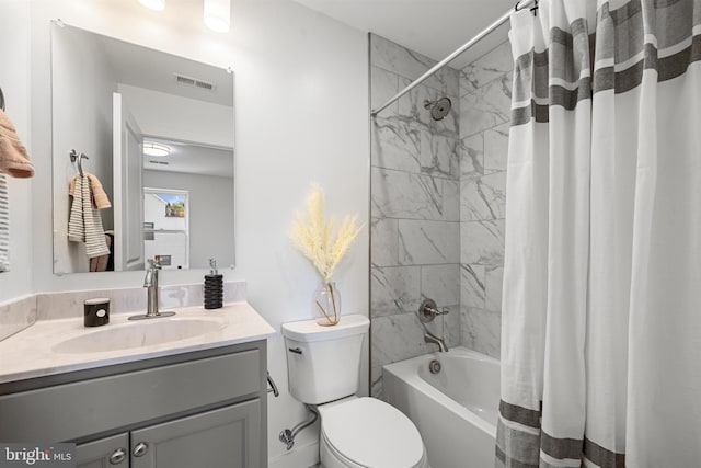 full bathroom featuring shower / bath combo with shower curtain, toilet, and vanity