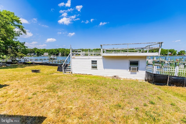 view of yard with a water view and a dock