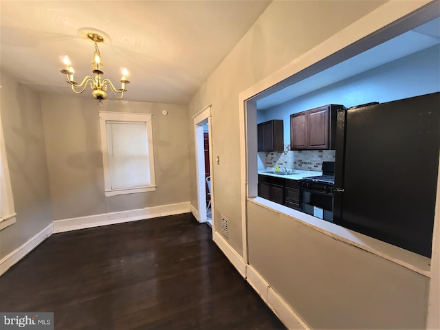 hall featuring dark hardwood / wood-style flooring, an inviting chandelier, and sink