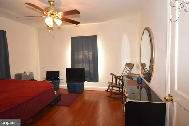 bedroom with dark hardwood / wood-style flooring and ceiling fan