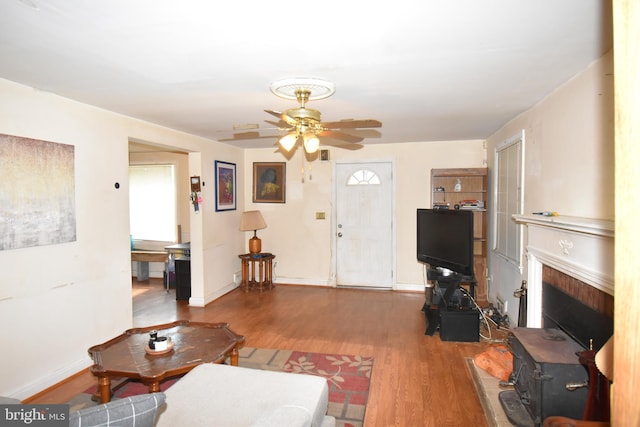 living room with ceiling fan and dark hardwood / wood-style floors