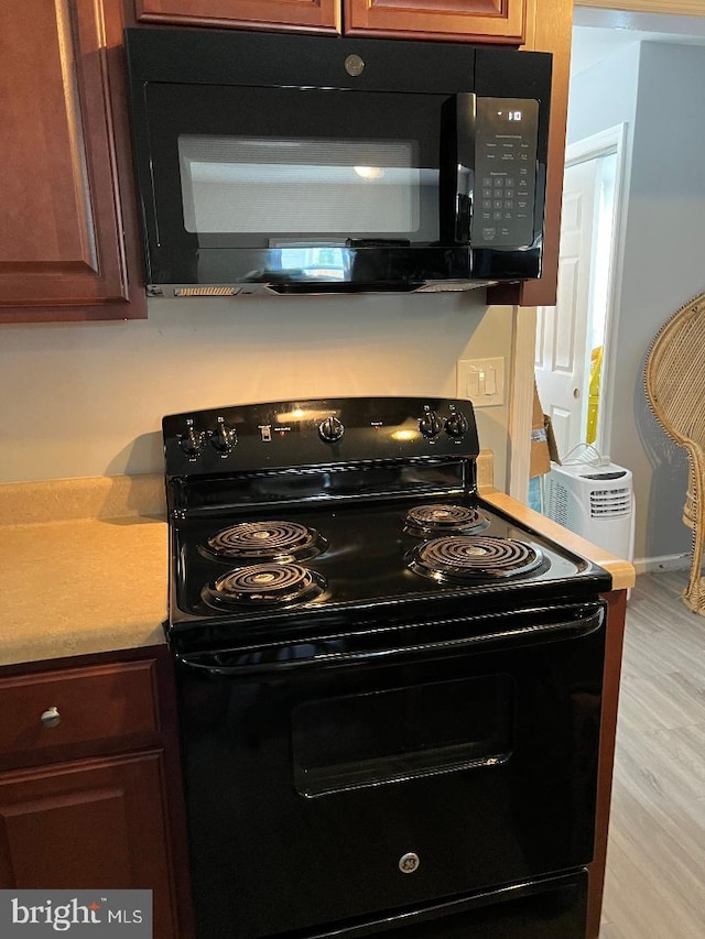 kitchen featuring light hardwood / wood-style flooring and electric range