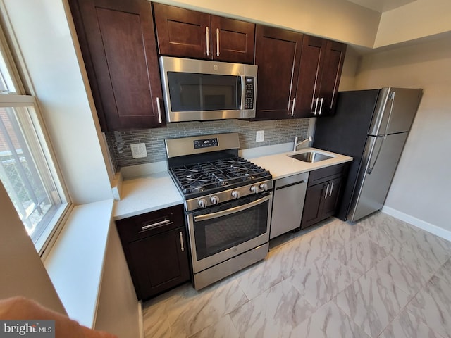 kitchen featuring appliances with stainless steel finishes, dark brown cabinets, backsplash, and light tile flooring