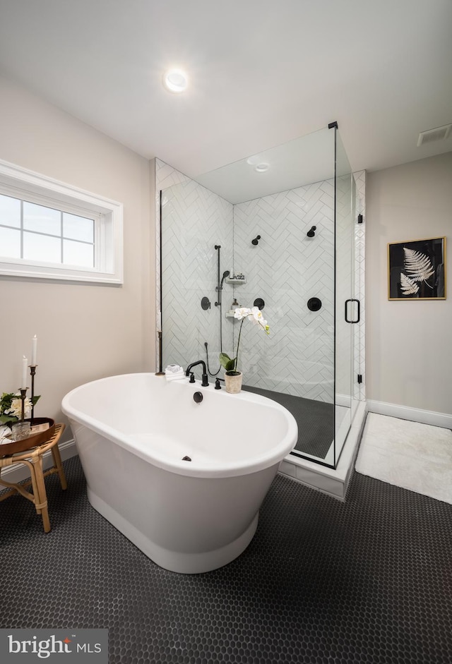 bathroom with tile patterned flooring and separate shower and tub