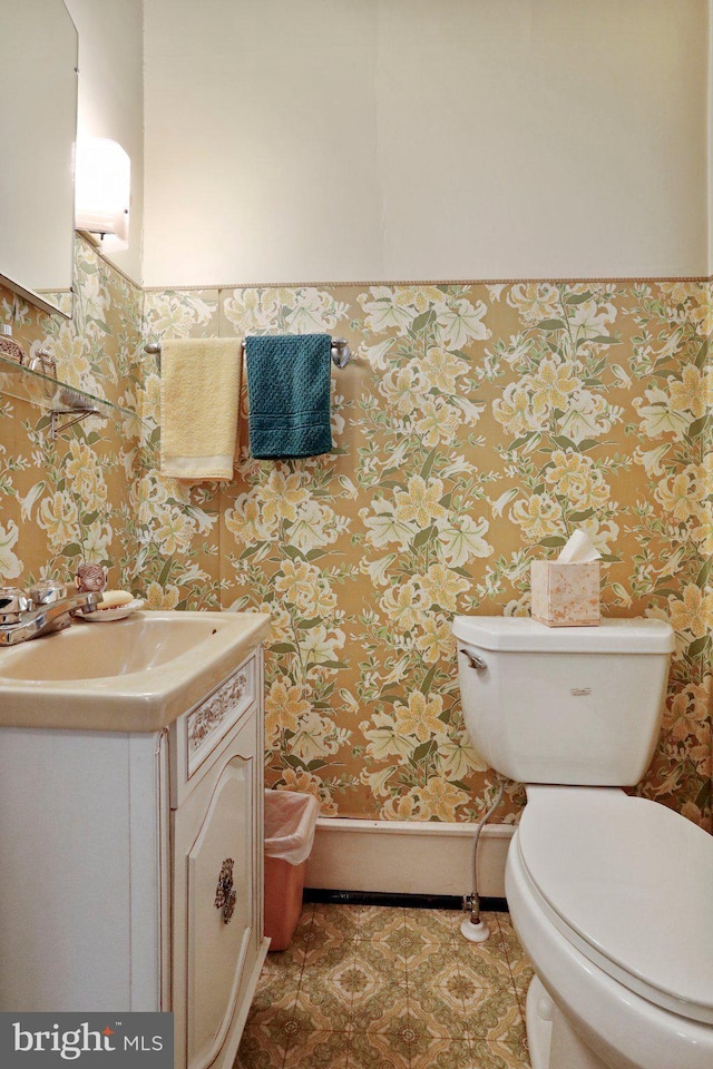 bathroom featuring toilet, tile patterned floors, and vanity