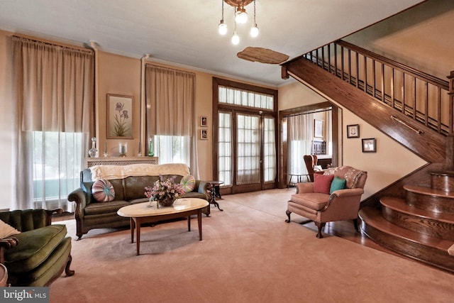 carpeted living room featuring ornamental molding