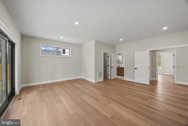 unfurnished bedroom featuring light wood-style flooring, baseboards, and visible vents