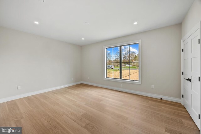 unfurnished bedroom with recessed lighting, baseboards, and light wood-type flooring
