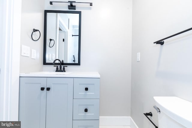 bathroom featuring toilet and vanity