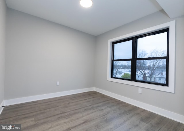 empty room with dark hardwood / wood-style floors