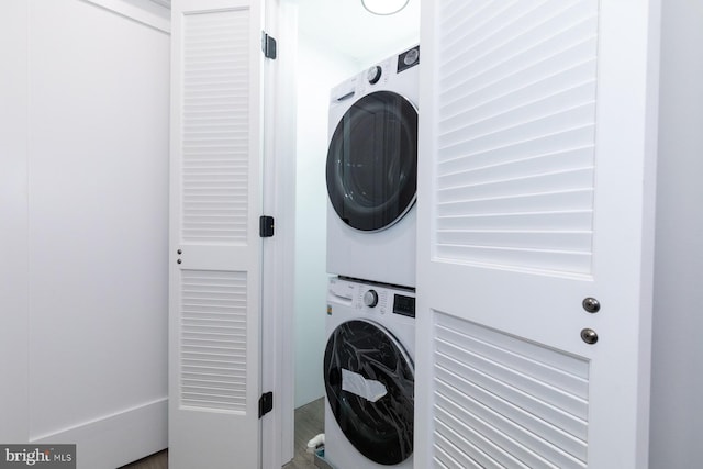 washroom featuring stacked washer and dryer