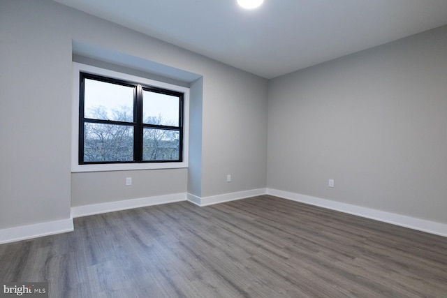 unfurnished room with dark hardwood / wood-style floors