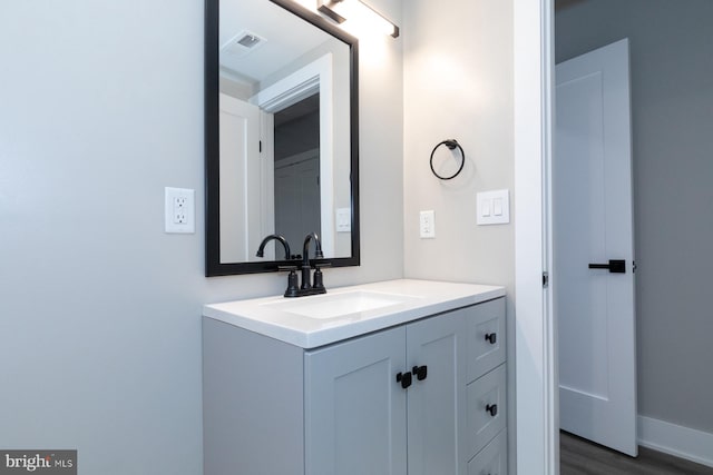 bathroom with hardwood / wood-style flooring and vanity