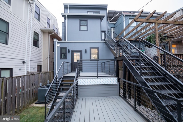 exterior space featuring central AC unit, a pergola, and a deck