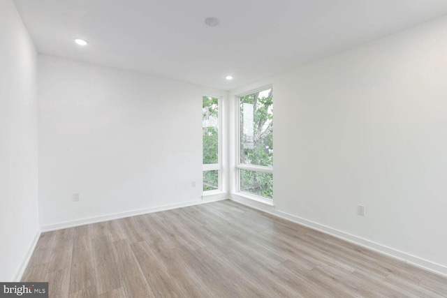 unfurnished room with light hardwood / wood-style flooring and a healthy amount of sunlight